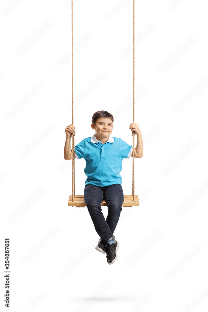 Happy little boy sitting on a swing and looking at the camera Happy little boy sitting on a swing and looking at the camera