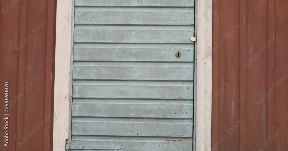 Old Abandoned Farm House barn with a time worn wooden door and a new padlock. Old Abandoned Farm House barn with a time worn wooden door and a new padlock.
