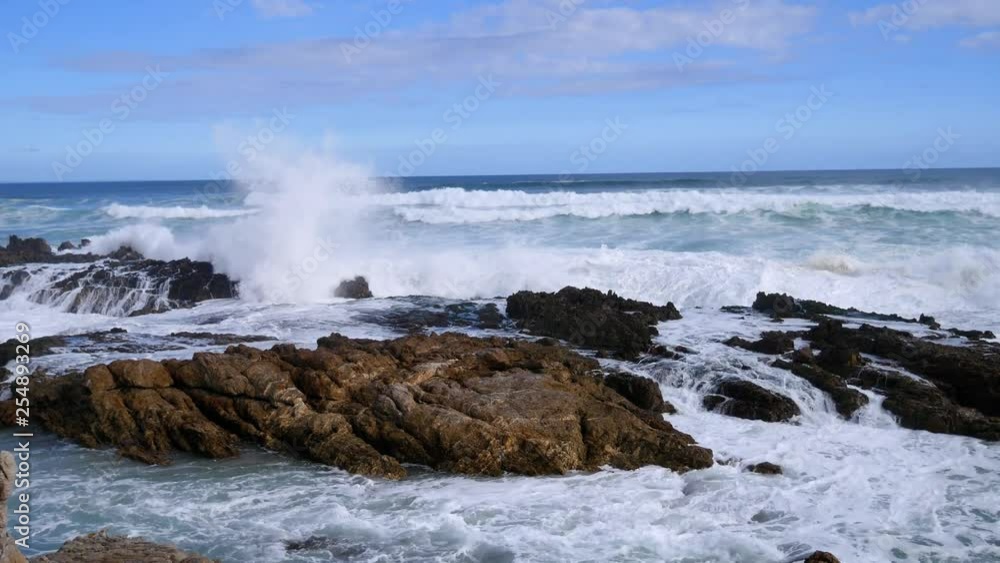 Rough ocean waves breaking onto rocky coastline in South Africa. Rough ocean waves breaking onto rocky coastline in South Africa.