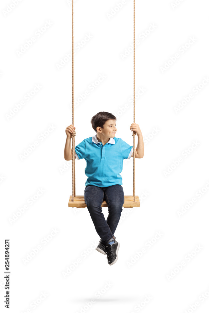 Boy sitting on a swing and looking away Boy sitting on a swing and looking away
