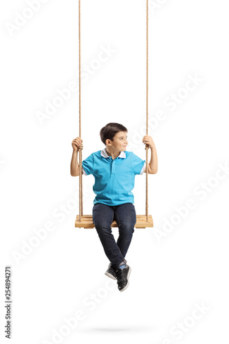 Boy sitting on a swing and looking away