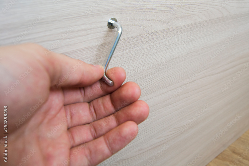 Hand with hexagon screwdriver