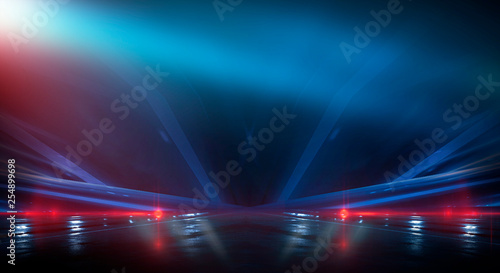 Background wall with neon lines and rays. Background of an empty dark corridor, parking, airport with neon light. Abstract background with lines and glow. Wet asphalt, the reflection of neon lights in