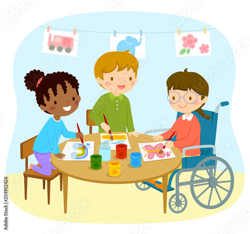 Disabled girl in a wheelchair drawing with her friends in the kindergarten