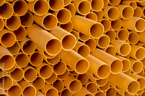 Side view of Abstract art structure created by stacking yellow pvc pipes together at an exhibition
