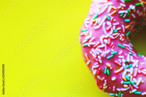pink donut on a yellow background close