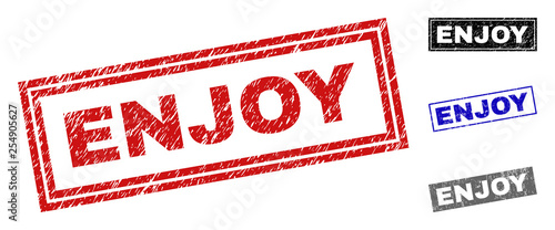 Grunge ENJOY rectangle stamp seals isolated on a white background. Rectangular seals with grunge texture in red, blue, black and gray colors.