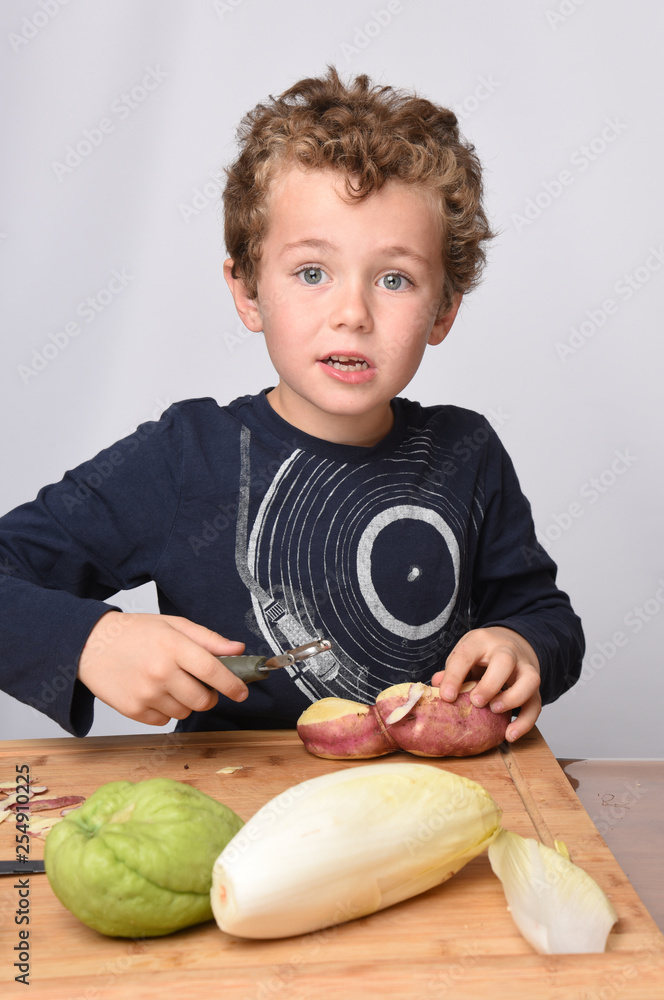 Fototapeta premium child peeling vegetables