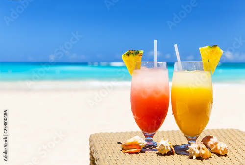 Fototapeta Naklejka Na Ścianę i Meble -  Two tropical fresh juices on white sandy beach