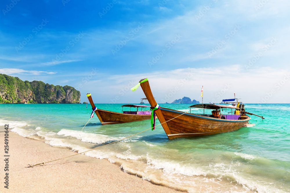 Thai traditional wooden longtail boat and beautiful sand