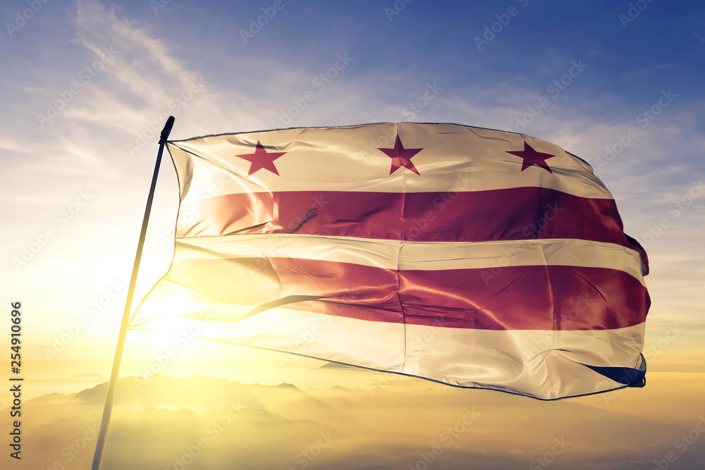 Washington DC of United States flag waving on the top sunrise mist fog