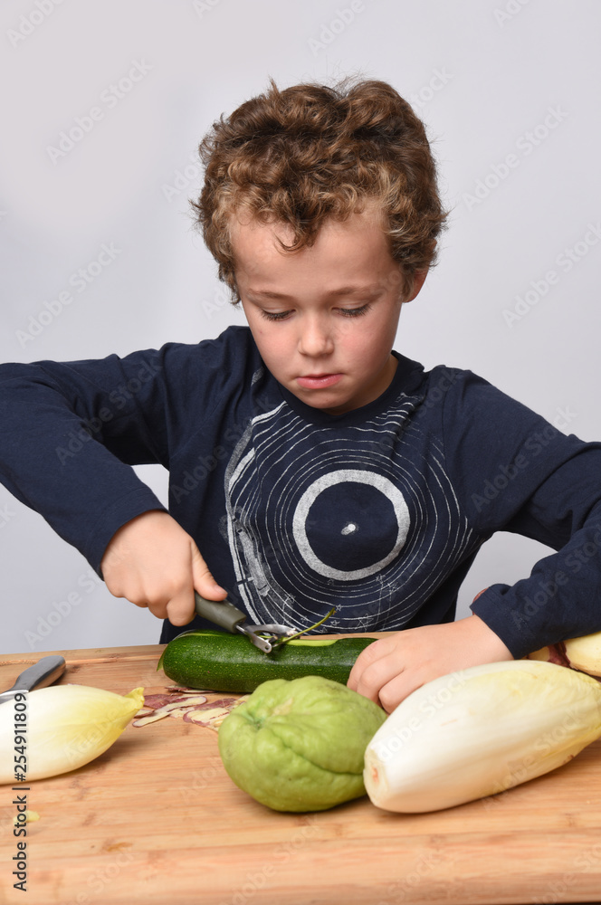 Fototapeta premium child peeling vegetables