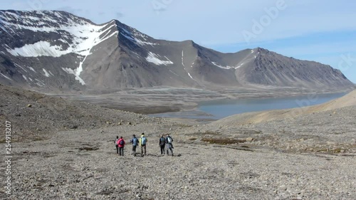 Hikers walk through the highlands of Svalbard