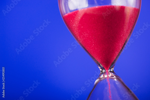 Bright colored pink sand with hourglass