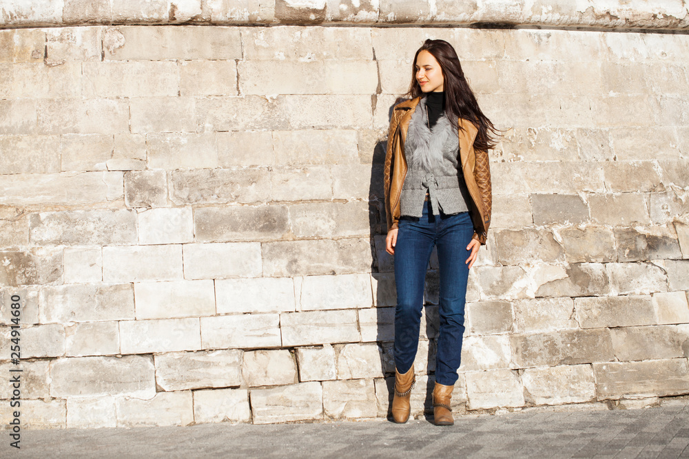 Young happy woman in brown leather jacket Young happy woman in brown leather jacket