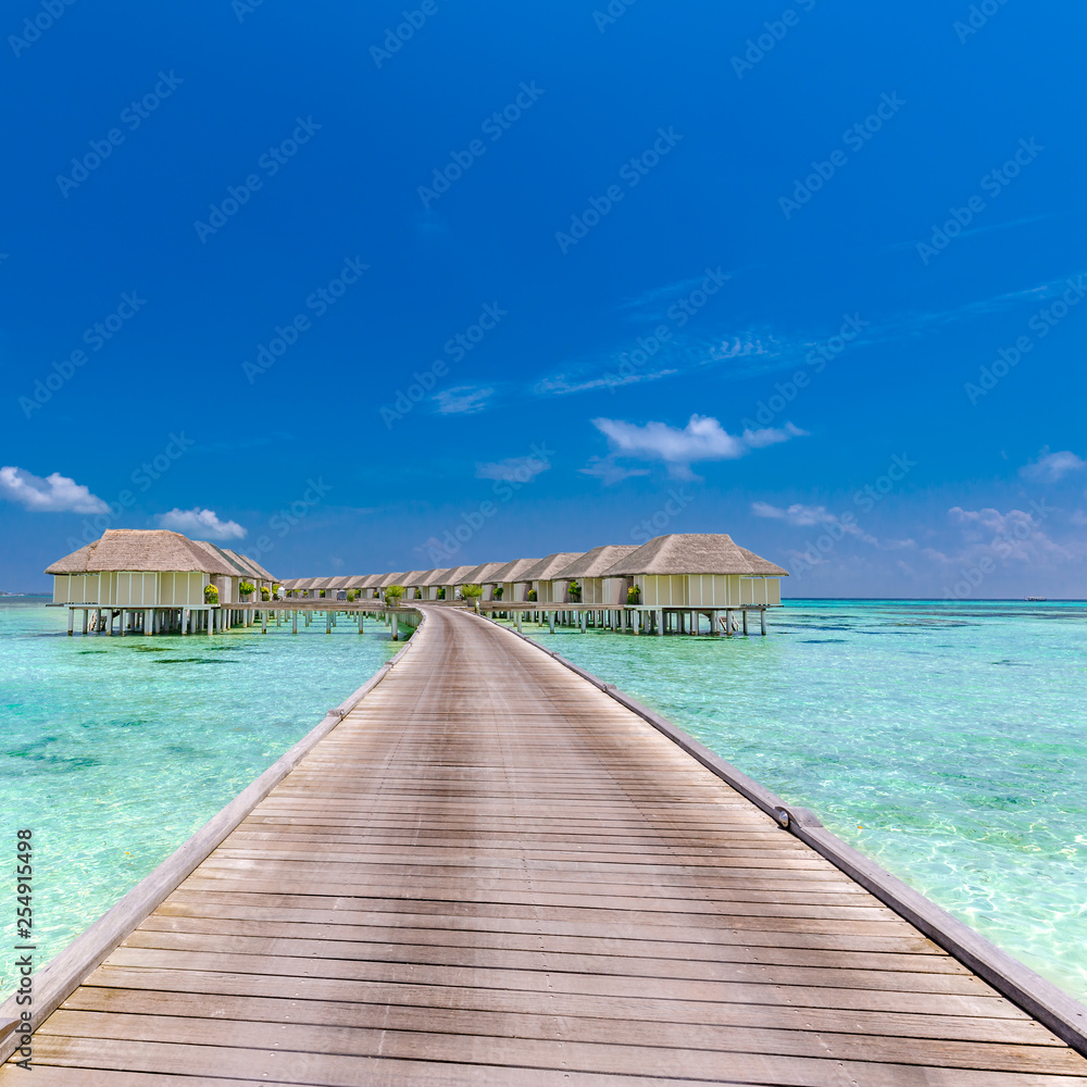 Landscape of Maldives beach. Tropical panorama, luxury water villa resort with wooden pier or jetty. Luxury travel destination background for summer holiday and vacation concept