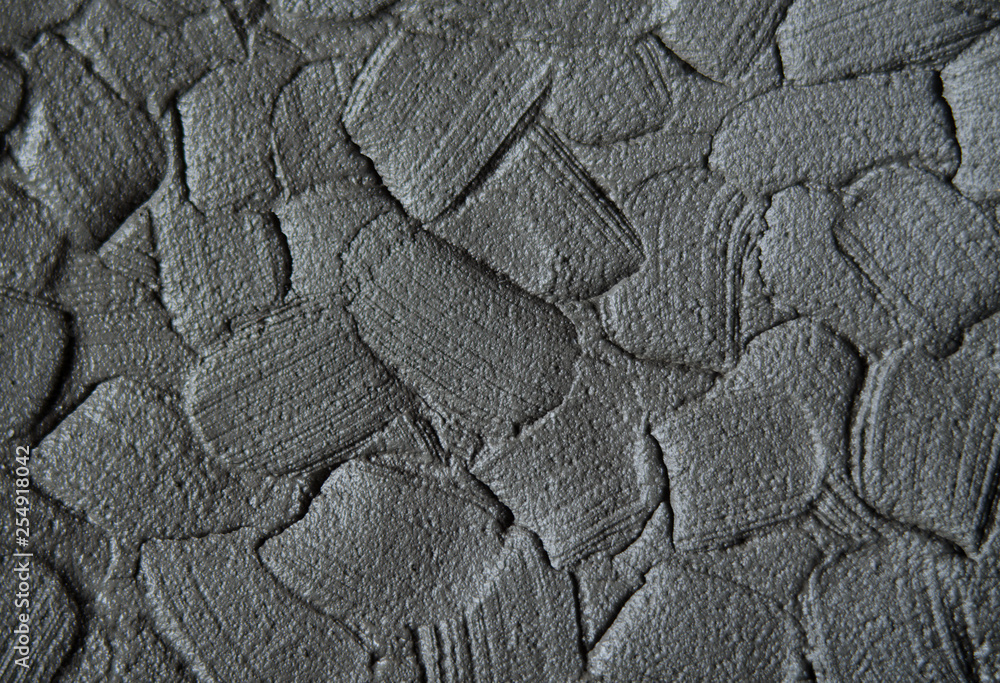 Black cosmetic clay/charcoal facial mask/cream/body wrap texture close up, selective focus. Abstract background with brush strokes. Black cosmetic clay/charcoal facial mask/cream/body wrap texture close up, selective focus. Abstract background with brush strokes.