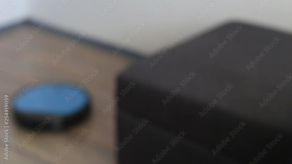 Person relaxing on a sofa with robot vacuum smart application control Person relaxing on a sofa with robot vacuum smart application control