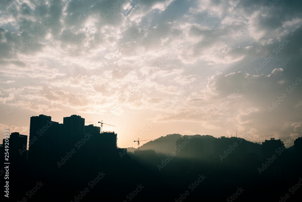 sunrise behind buildings in chongqing, china sunrise behind buildings in chongqing, china