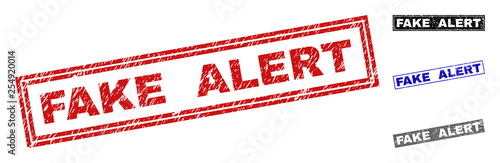 Grunge FAKE ALERT rectangle stamp seals isolated on a white background. Rectangular seals with grunge texture in red, blue, black and gray colors.