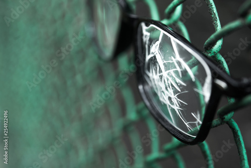 Close up of broken glasses on a metal lattice