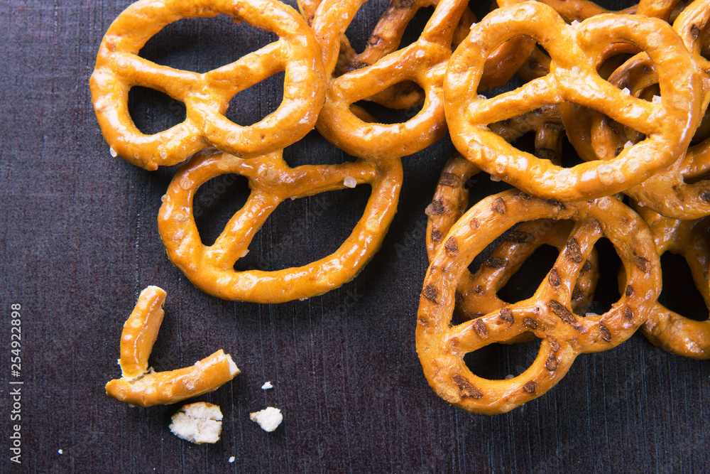 Salted pretzels on wooden background top view Salted pretzels on wooden background top view