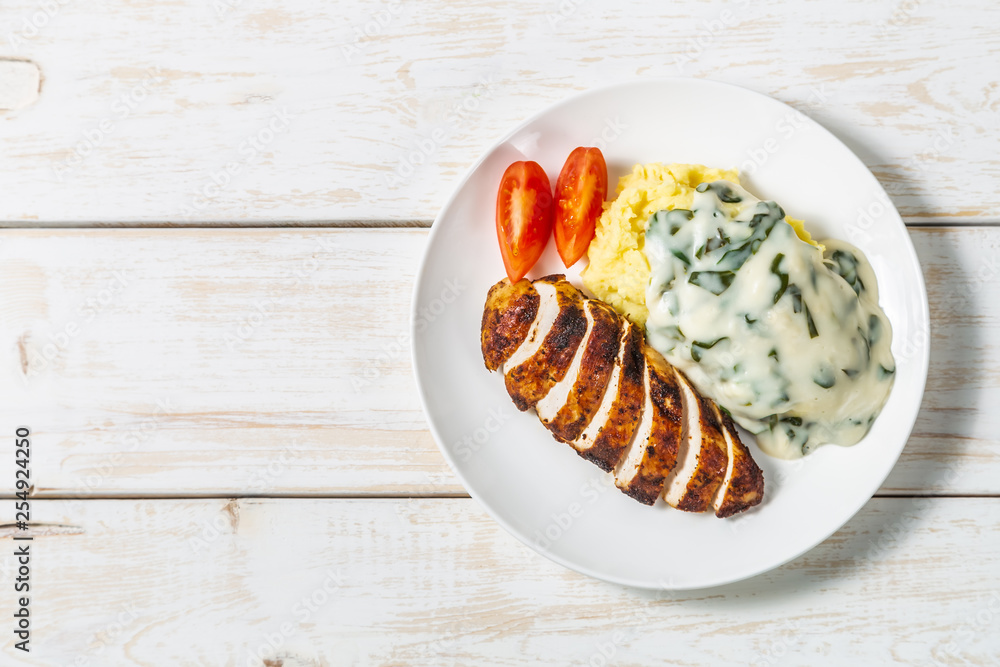 Chicken breast, mashed potatoes with spinach in cream sauce. Dietary food. The view from the top. Copy-space. Chicken breast, mashed potatoes with spinach in cream sauce. Dietary food. The view from the top. Copy-space.