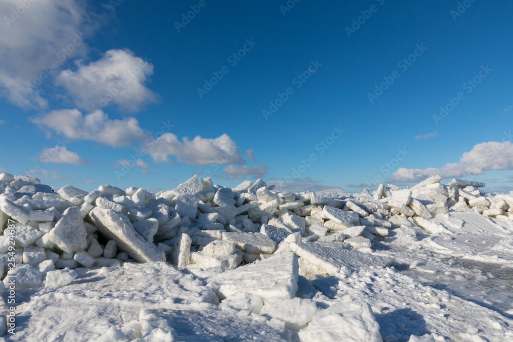 Seaside with frozen and melting ice with rocks Seaside with frozen and melting ice with rocks