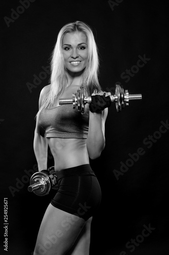 Athletic young woman doing workout with weights