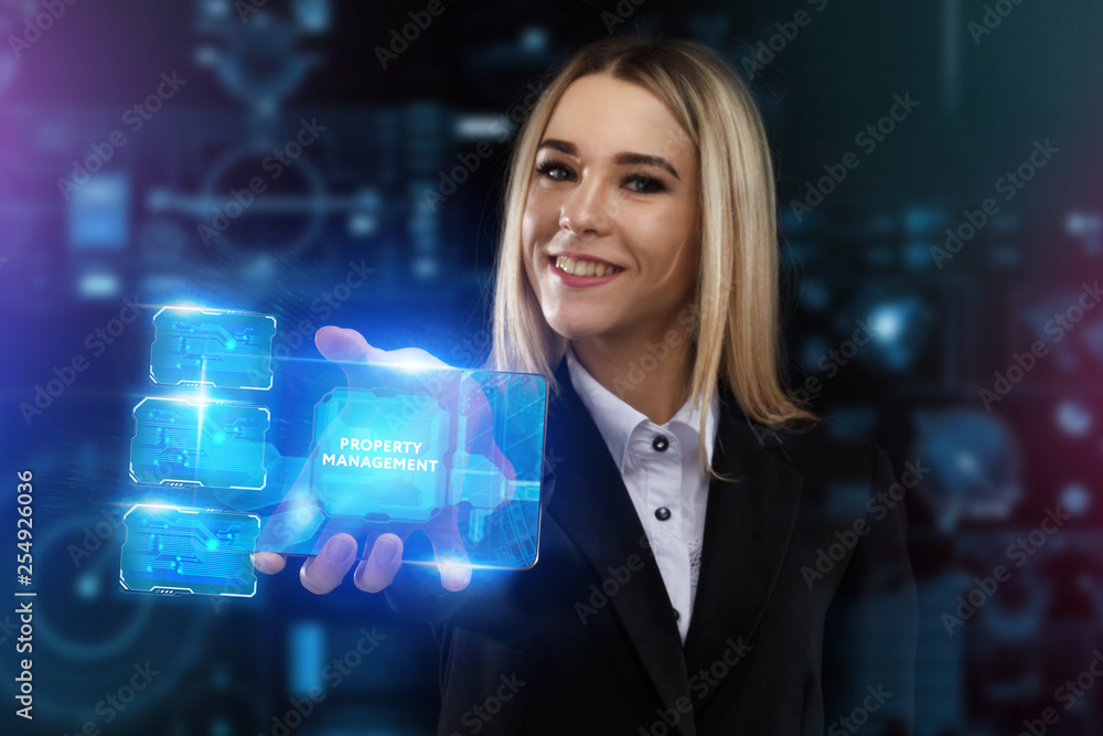 The concept of business, technology, the Internet and the network. A young entrepreneur working on a virtual screen of the future and sees the inscription: Property management The concept of business, technology, the Internet and the network. A young entrepreneur working on a virtual screen of the future and sees the inscription: Property management