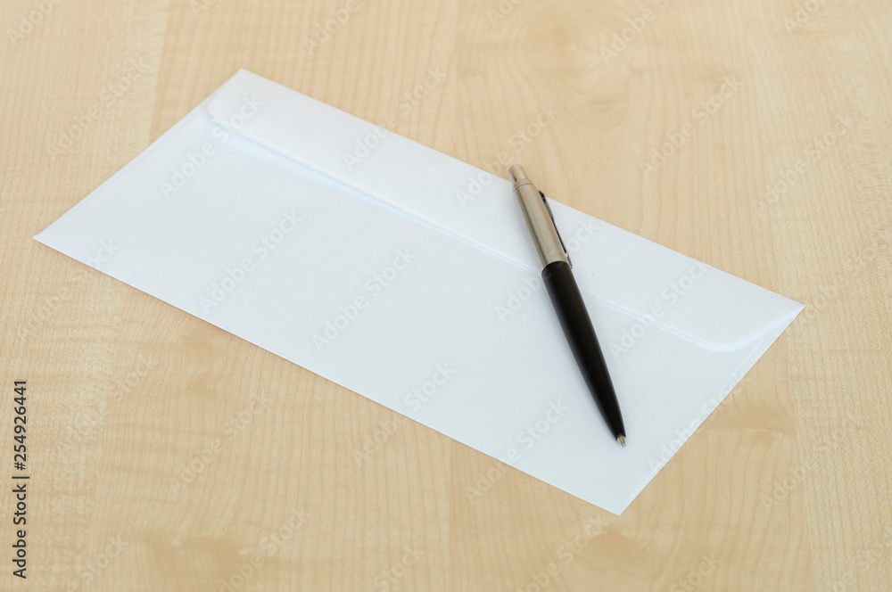 pen and a white envelope on the Desk pen and a white envelope on the Desk