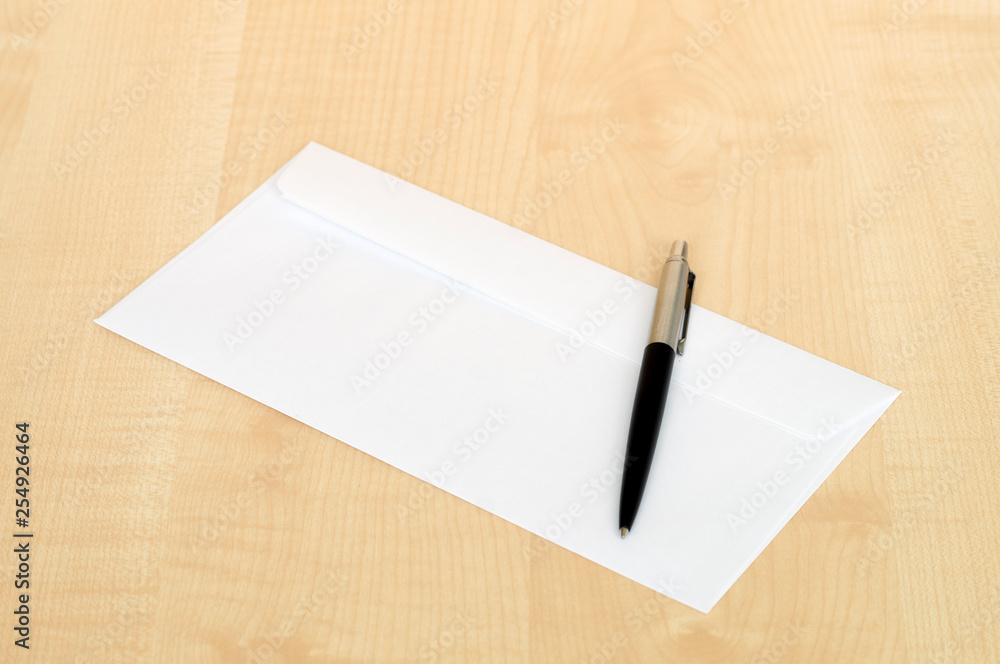 pen and a white envelope on the Desk pen and a white envelope on the Desk