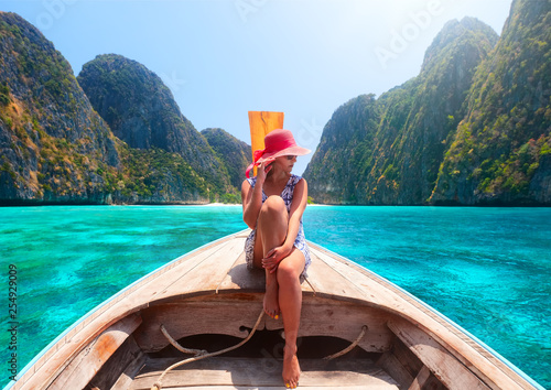Murais de parede woman traveling by boat in summer vacation among the islands Phi Phi and Maya beach in Thailand