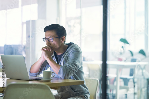 Photography Portrait of Asian businessman working on laptop in office
