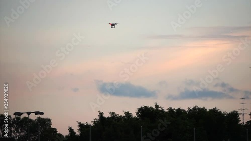 Drone flying up distance at evenign sky photo