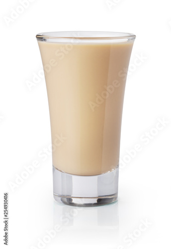 Cream liqueur shooter in a shot glass on white background