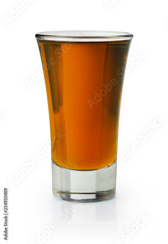 Brown spirit shooter in a shot glass on white background