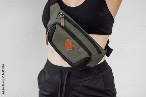 Fényképezés Sporty girl with fanny bag on white background
