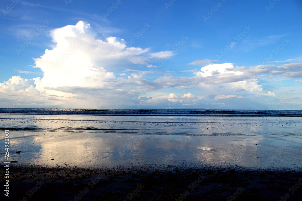 Scenery of the clouds in blue sky and sea with the beach in the evening time Scenery of the clouds in blue sky and sea with the beach in the evening time