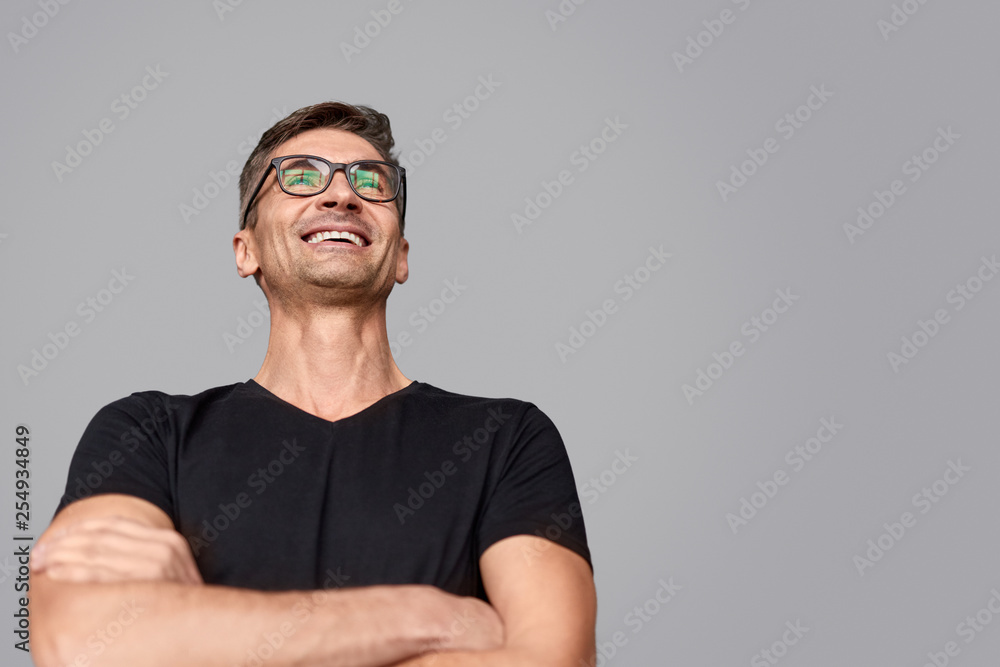 Excited man in glasses looking away Excited man in glasses looking away