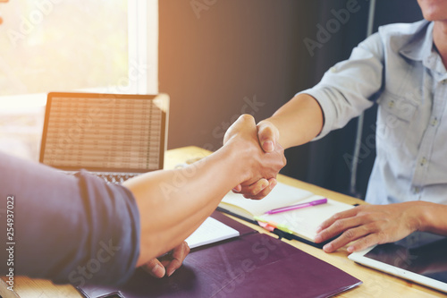 Businessmen shaking hands together happy. After the negotiations were successful