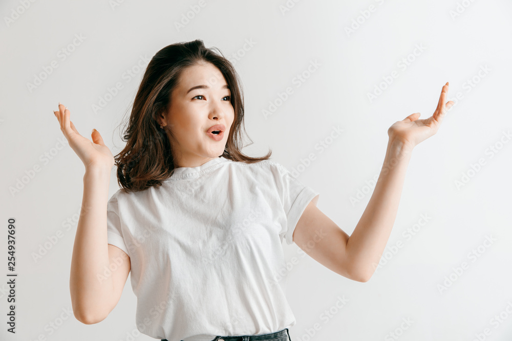 I won. Winning success happy woman celebrating being a winner. Dynamic image of asian female model on gray studio background. Victory, delight concept. Human facial emotions concept. I won. Winning success happy woman celebrating being a winner. Dynamic image of asian female model on gray studio background. Victory, delight concept. Human facial emotions concept.