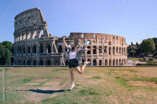 girl jumping in front of the colosseum in Rome