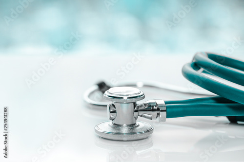 Stethoscope or phonendoscope on a doctor's white desk on cloudy morning. Treatment of cold or flu.