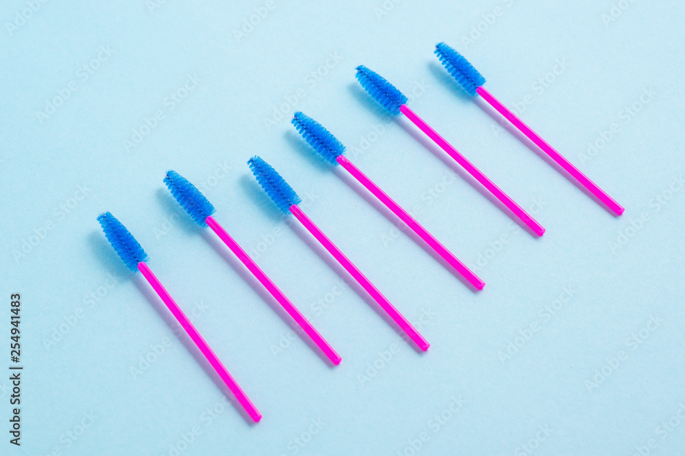Disposable pink brushes for eyelashes and eyebrows. Close-up.