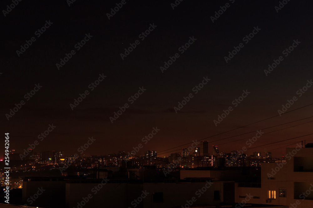City skyline at night. Amazing panoramic view of modern city.Construction site with cranes on new residential areas