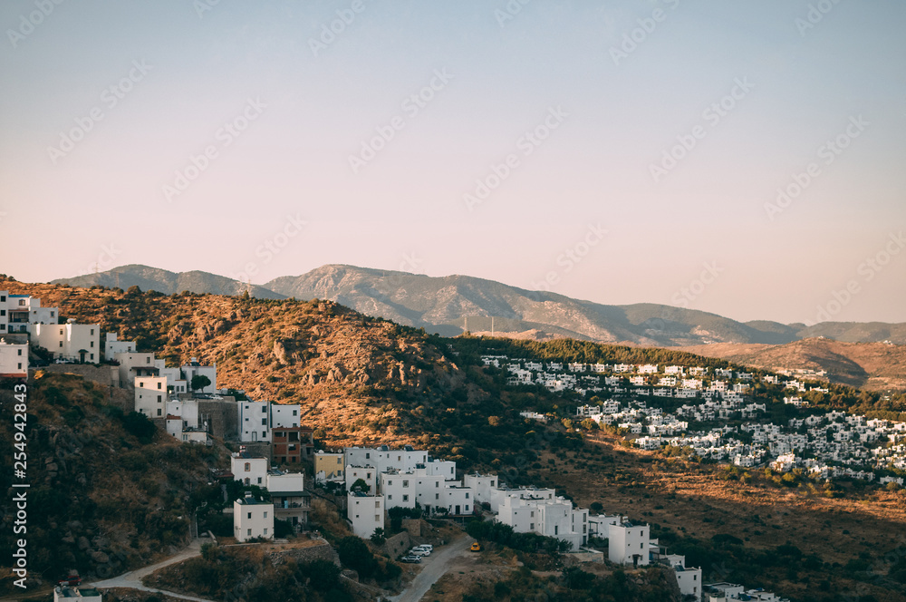 Obraz premium Typical white, cubic Bodrum houses in Turkey with a sea view, during sunset, summer