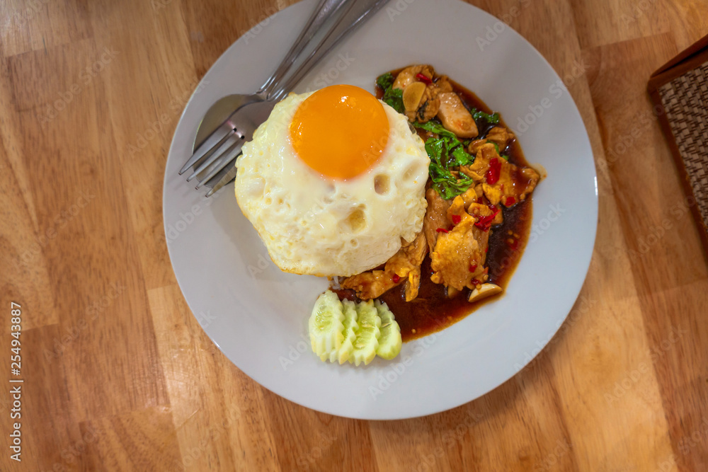 Rice topped with stir-fried chicken  and fried egg Thailand food.