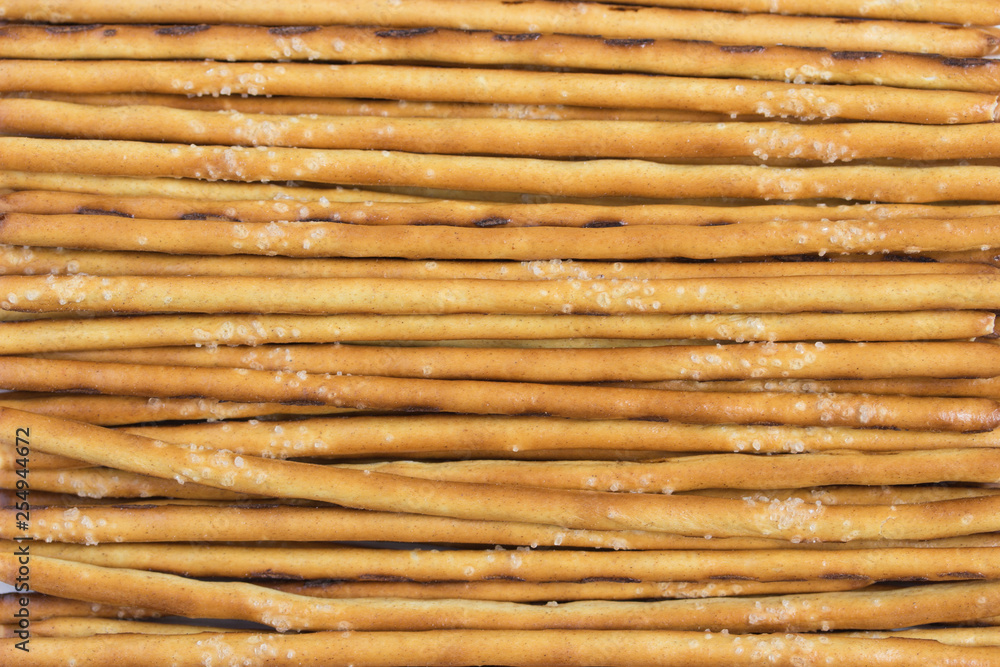 Salty dough straw, cracker snack, crispy breadsticks, close-up background Salty dough straw, cracker snack, crispy breadsticks, close-up background
