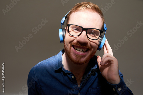 Cheerful businessman in headphones © DragonImages